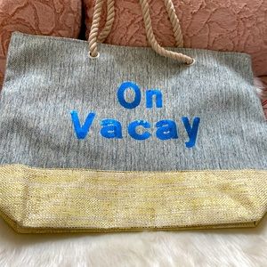 On vacay large tote with rope like design handles.